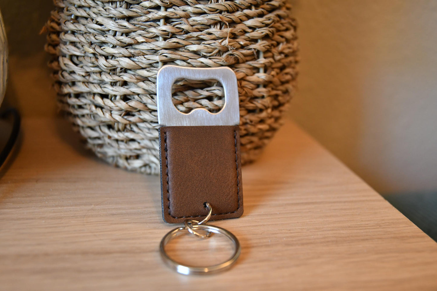 a leather keychain with a key ring on a table