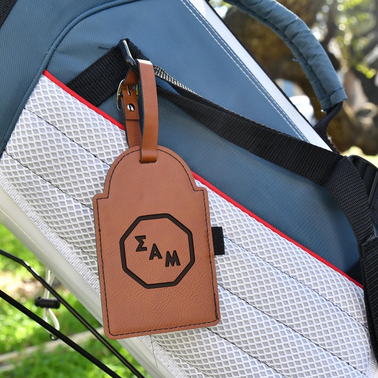 a luggage tag is attached to the handle of a bag