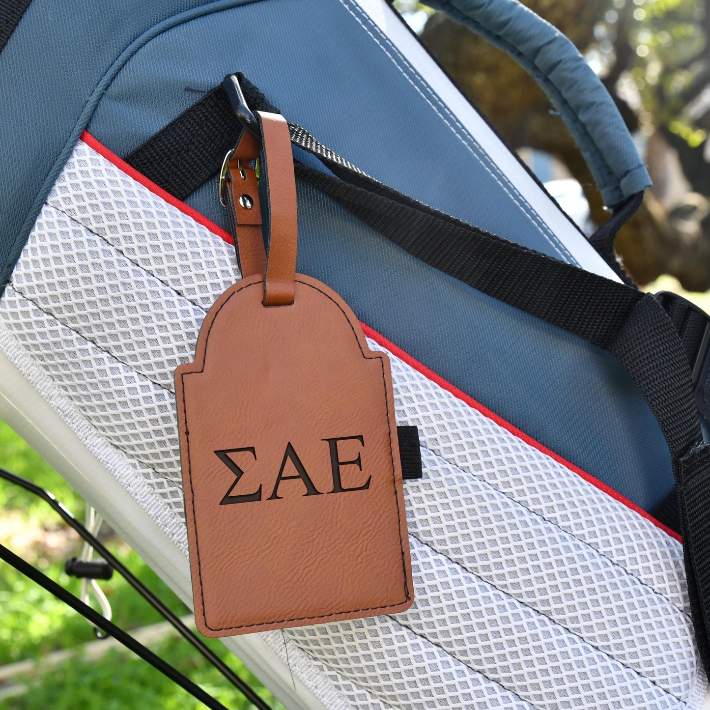 a luggage tag is attached to the handle of a bag