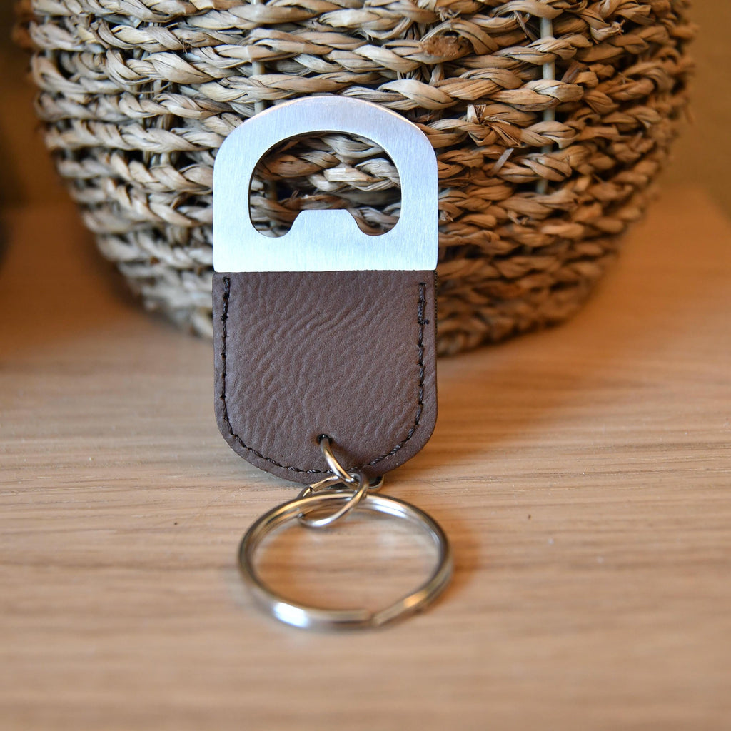 a leather keychain with a metal keyring attached to it
