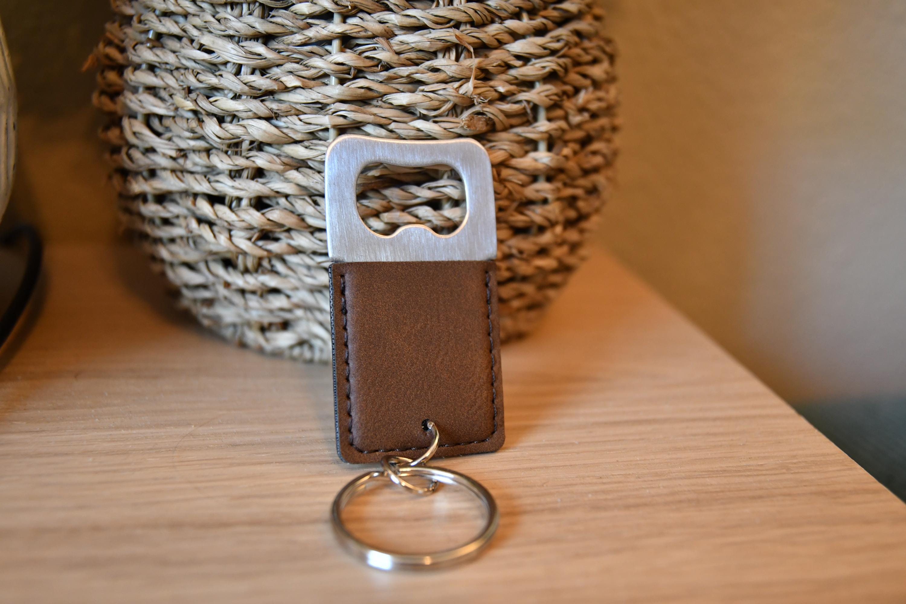 a leather keychain with a key ring on a table