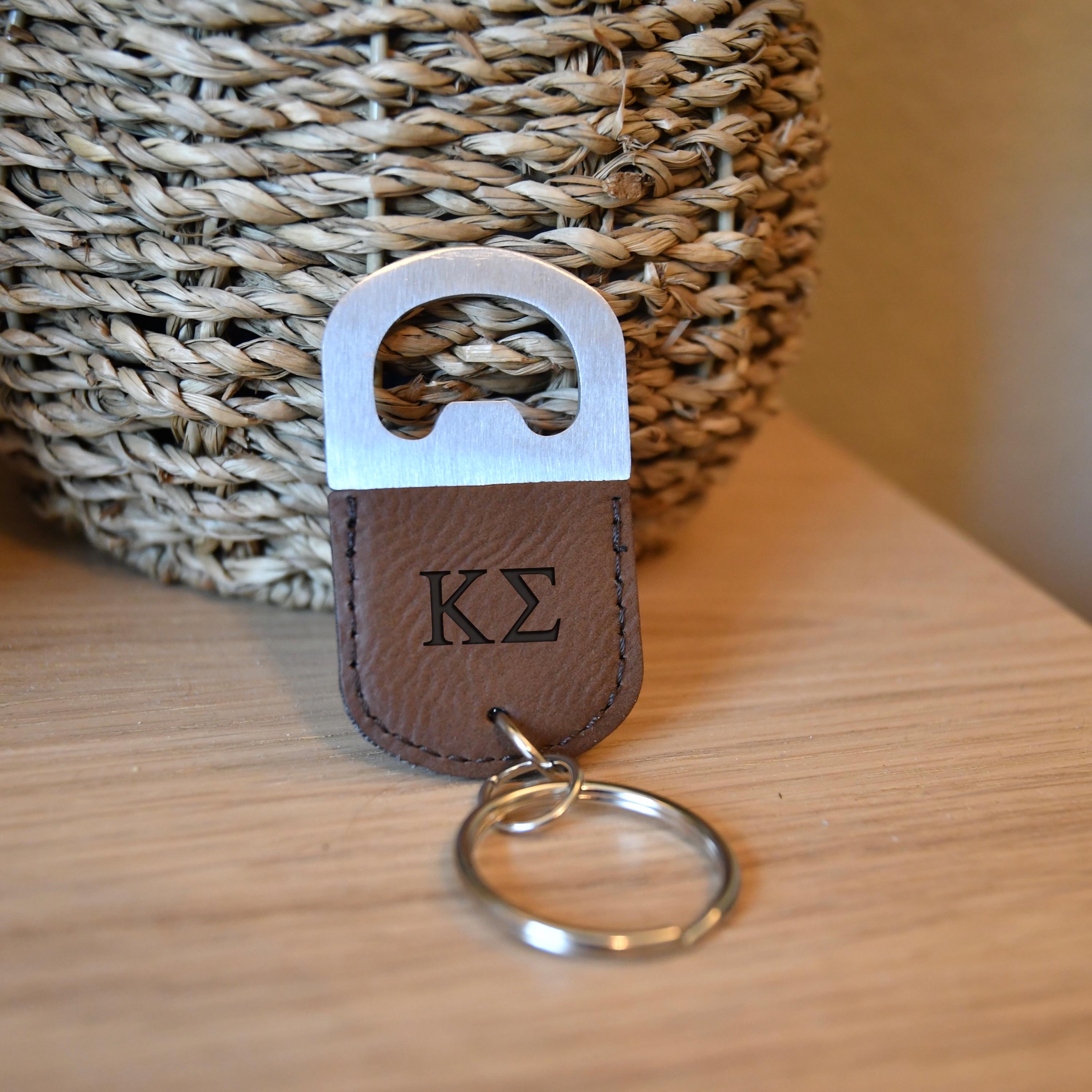 a keychain with a kz logo on it